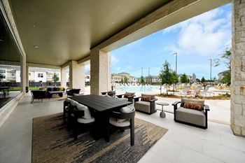 Luxurious poolside covered patio with soft seating
